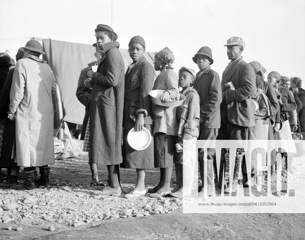 African Americans in the lineup for food at mealtime in the camp for flood refugees at Forrest City, Arkansas, 1937 (b w photo) 3666465 African Americans in the lineup for food at mealtime in the camp for flood refugees at Forrest City, Arkansas, 1937 (b w photo) by Evans, Walker (1903-75); Private Collection; (add.info.: Photograph possibly taken for the U.S. Resettlement Administration: a New Deal U.S. federal agency that, between April 1935 and December 1936, relocated struggling urban and rural families to communities planned by the federal government.).