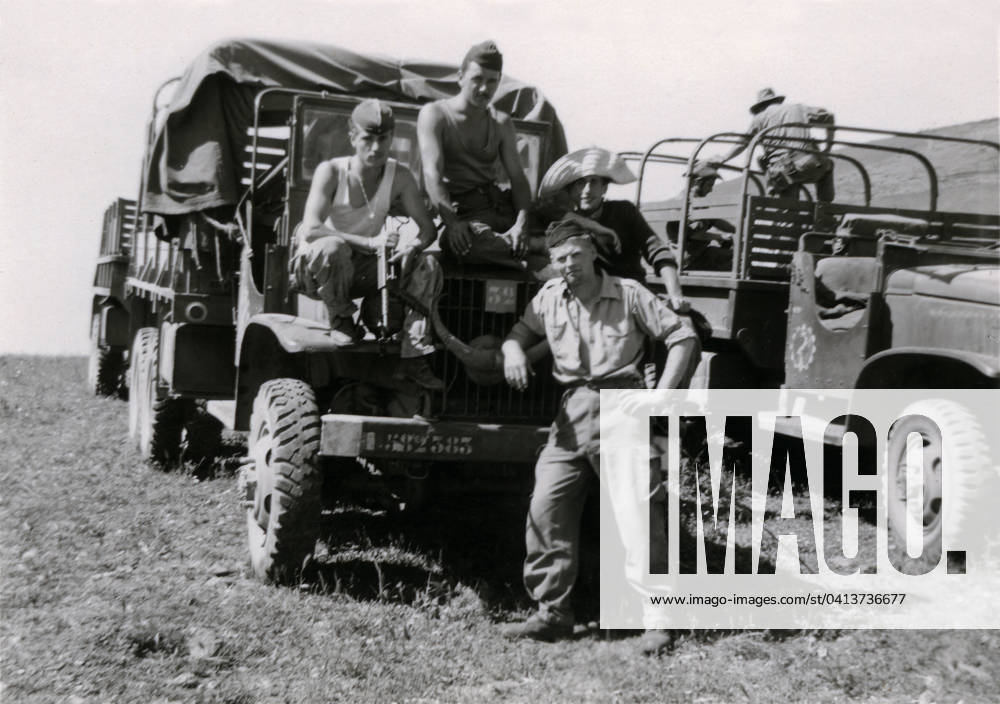 A group of 4 young French soldiers in Algeria between 1958 and 1962 (1960s) in front of military trucks (b w photo) PCT4294088 A group of 4 young French soldiers in Algeria between 1958 and 1962 (1960s) in front of military trucks (b w photo); (add.info.: A group of 4 young French soldiers in Algeria between 1958 and 1962 (1960s) in front of military trucks - photo from family archives, undated and uncredited - Algerian war, French army, colony, French colonies, Algerian desert, Jebel); Patrice Cartier. All rights reserved 2023.