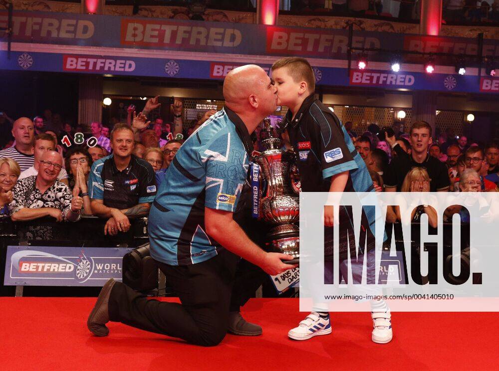 KW30 28th July 2019, Empress Ballroom Winter Gardens Blackpool; 2019 Betfred World Matchplay Darts; Final; Rob Cross (ENG) and his son with the World Matchplay trophy after his victory over Michael Smith (ENG) ActionPlus12157119 AlanxMartin