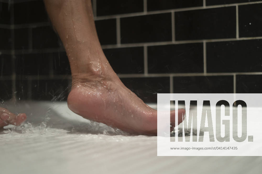 Unidentified person s bare foot in shower