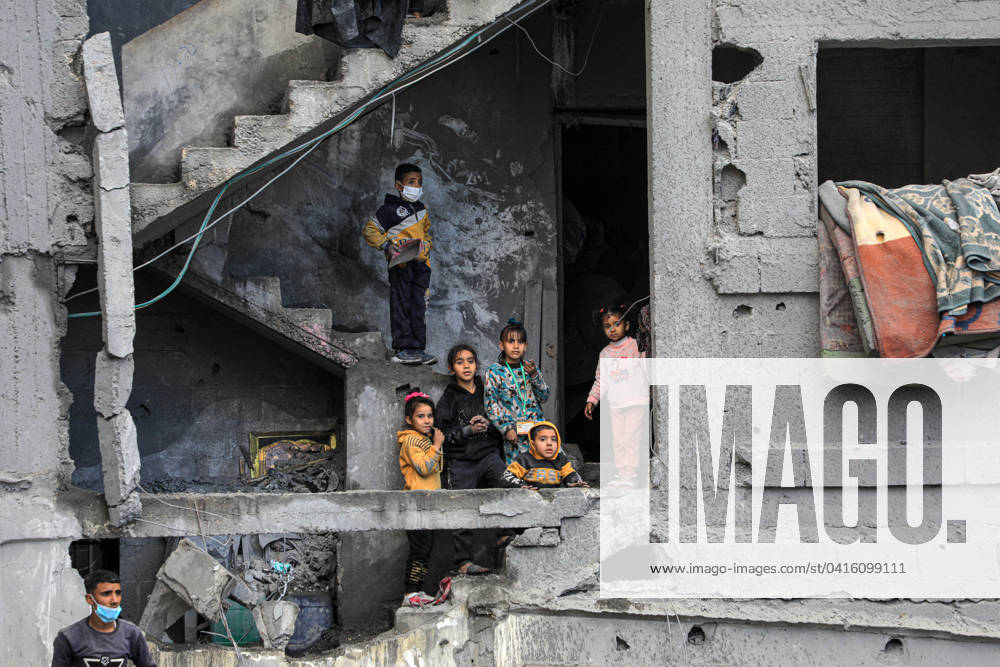 (240222) -- RAFAH, Feb. 22, 2024 -- Children are seen in a building destroyed in an Israeli air strike in the southern Gaza Strip city of Rafah, Feb. 22, 2024. The Palestinian death toll from the ongoing Israeli attacks on Gaza has risen to 29,410, with 69,465 others wounded since the Israel-Hamas conflict broke out, Hamas-run Health Ministry said in a press statement on Thursday. It added that the Israeli army killed 97 Palestinians and wounded 132 others during the past 24 hours, noting that some victims remain under the rubble amid heavy bombardment and a lack of civil defense and ambulance crews. (Photo by Xinhua) MIDEAST-GAZA-PALESTINIAN DEATH TOLL RizekxAbdeljawad