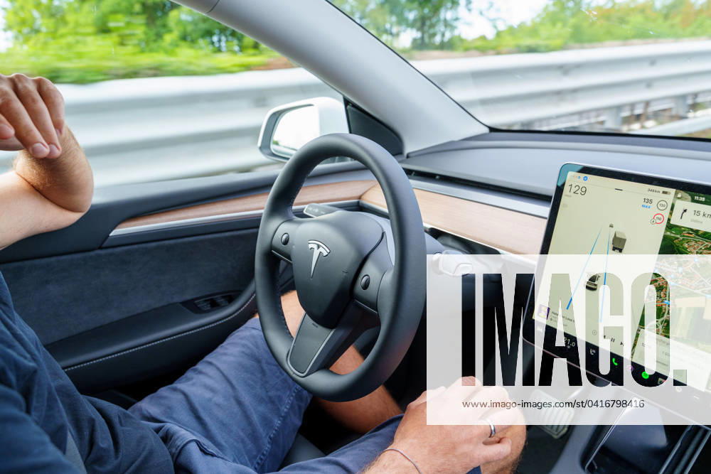 Man drives Tesla Model Y car on highway with autopilot without hands on steering wheel