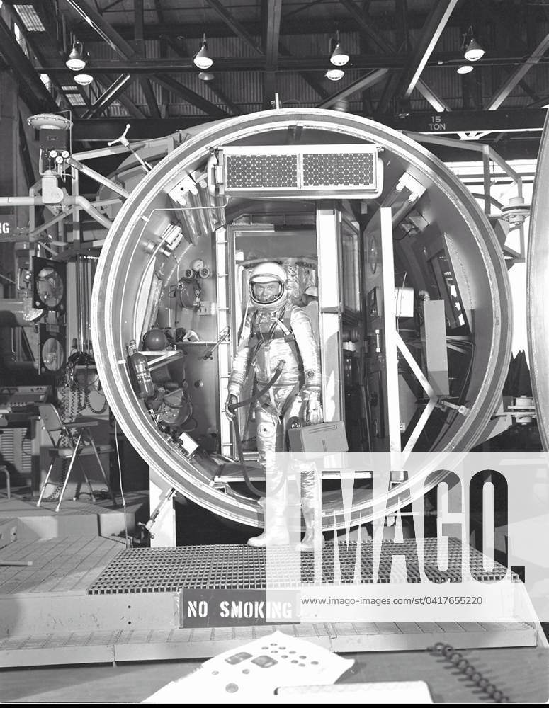 Glenn Altitude Chamber Test Astronaut John H. Glenn Jr., suited with hose to suit ventilation unit attached, during altitude chamber test in 1961. He is standing in the entrance to the test chamber with his helmet visor down..Credit: NASA via CNP Houston Texas United States of America