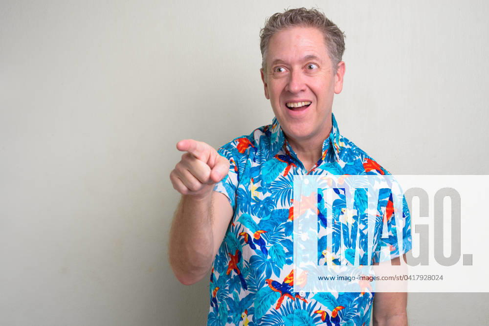 Portrait of mature tourist man ready for vacation Studio shot of mature tourist man ready for vacation against white background ,model released, Symbolfoto