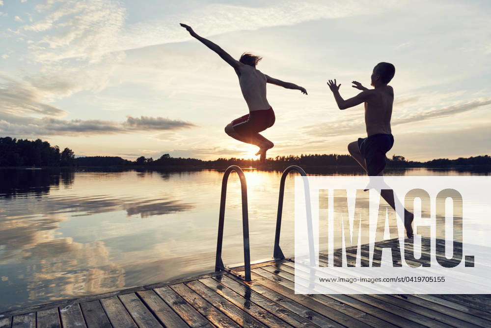 Boys jumping into lake , model released