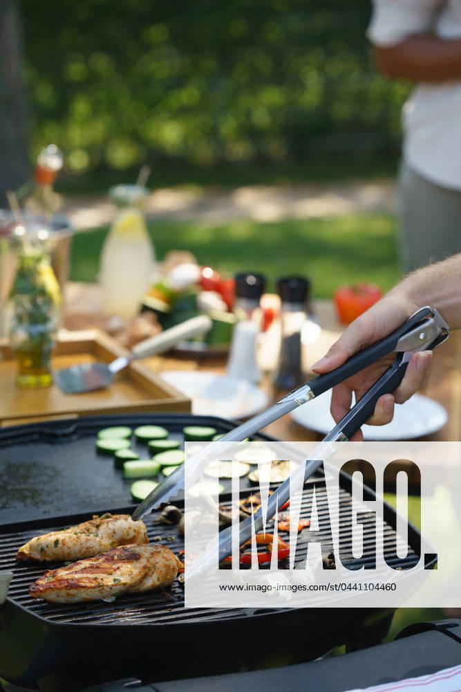 Meat and vegetables grilling on outdoor grill. Outdoor grill or BBQ party in the garden. Meat and vegetables grilling on an outdoor grill. Outdoor grill or BBQ party in the garden. model released