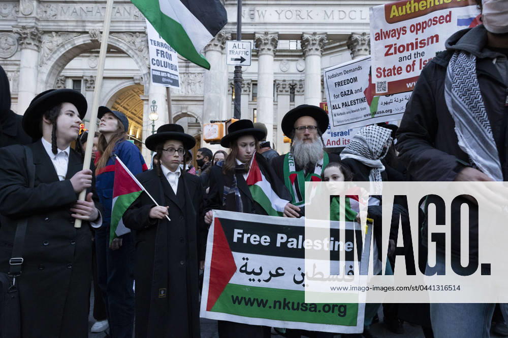 Members of Neturei Karta march with demonstrators. An emergency action for Gaza in response to the bombing of Al-Shifa Hospital brought hundreds of protesters to the City Hall area where Eric Adams was hosting a Ramadan Iftar. Protesters marched through the Civic Center area of Manhattan moving back and forth from the streets to the sidewalks with NYPD threatening arrest for blocking the roadways. Hundreds of police officers surrounded the Surrogateâ€⠢s Court Hall of Records where Mayor Adams event was taking place as well as following the protesters. A sign reads Free Palestine. New York USA - ZUMAr174 20240319_znp_r174_027