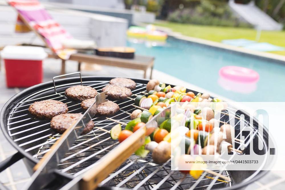 Burgers and vegetable skewers are grilling by a poolside Burgers and vegetable skewers are grilling by a poolside. Lounge chairs and a pink float suggest a relaxed outdoor barbecue setting., model released, , property released, Cape Town, South Africa, 15.11.2023, 4951672.jpg, burgers,vegetable skewers,grilling,poolside,lounge chairs,pink float,outdoor barbecue,relaxed setting,summer,food,cooking,delicious,meal,lunch,dinner,barbecue party,outdoor,pool,relaxation,leisure,fun,friends,family,gathering,tasty,skewers,meat,vegetables,cookout,grill,sunny,day,entertainment,outdoor cooking,fresh,BBQ,hamburgers,kebabs,snacks,party,socializing,summer joy,vacation,picnic