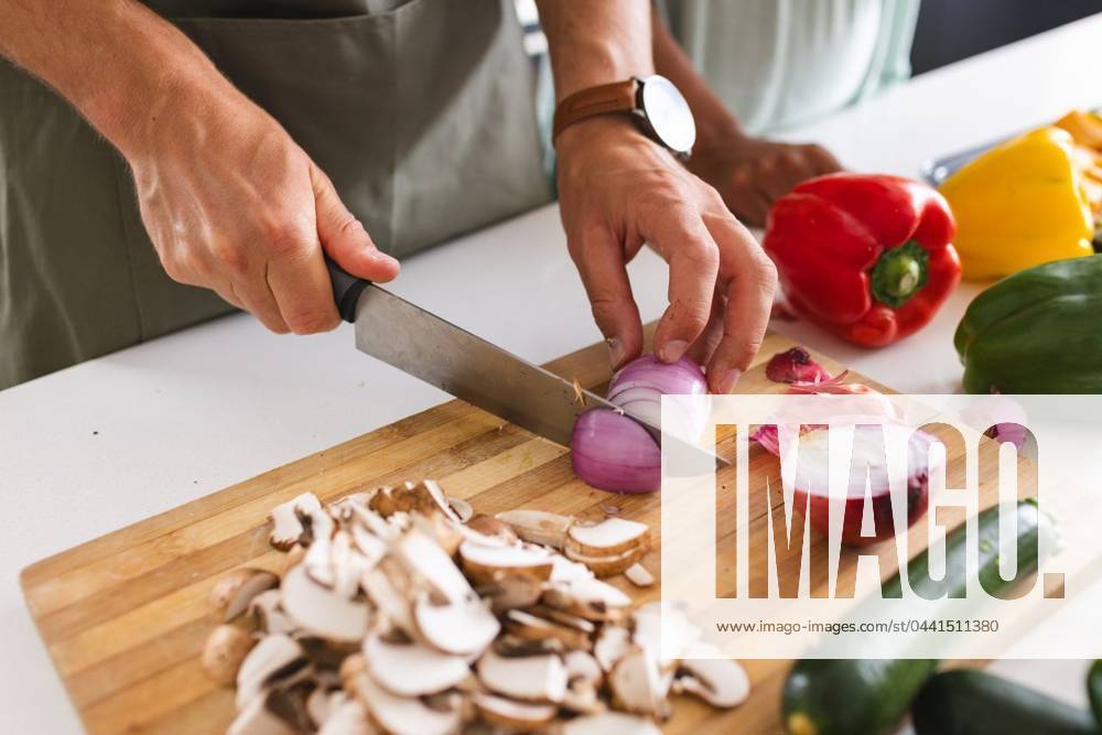 IMAGO Creative, Food, Trend, Meal Prep A person is chopping vegetables on a wooden cutting board in a kitchen A person is chopping vegetables on a wooden cutting board in a kitchen. Wearing a gray apron and a wristwatch, the focus is on meal preparation with colorful bell peppers nearby., model released, , property released, Cape Town, South Africa, 15.11.2023, 4961140.jpg, people,chopping vegetables,wooden cutting board,kitchen,meal preparation,colorful bell peppers,gray apron,wristwatch,cooking,food,chef,preparing,healthy,fresh,organic,nutrition,culinary,cuisine,chef s knife,kitchenware,chopping board,vegetables,meal,preparing food,cooking process,apron,bell peppers,kitchen tools,meal prepping,cooking utensils,kitchen essentials,food ingredients,cooking accessories,meal prep,