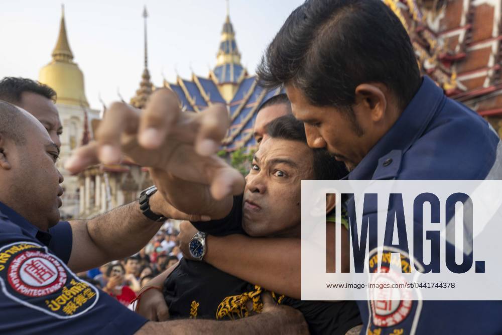 Devotees who have had sacred sak yant tattoos fall into a state of possession and violenty toward the temple during the annual Wai Kru ceremony at Wat Bang Phra in Nakhon Pathom, Thailand.Wat Bang Phra temple, 40 km away from the Thai capital Bangkok, hosts the Wai Gru ceremony once a year. The temples name translate as Monastery of the Riverbank Buddha Image. Sak Yant tattoos are highly stylized tattoos of Buddhist prayers and religious symbols, thought to bring special protection and other benefits to the faithful who have them put upon their bodies. Many attendees fall into a state of spirit possession on the the temple grounds after having tattoos made. The Sak Yant tattoos are made by hand with - ZUMAt128 20240323_zap_t128_003