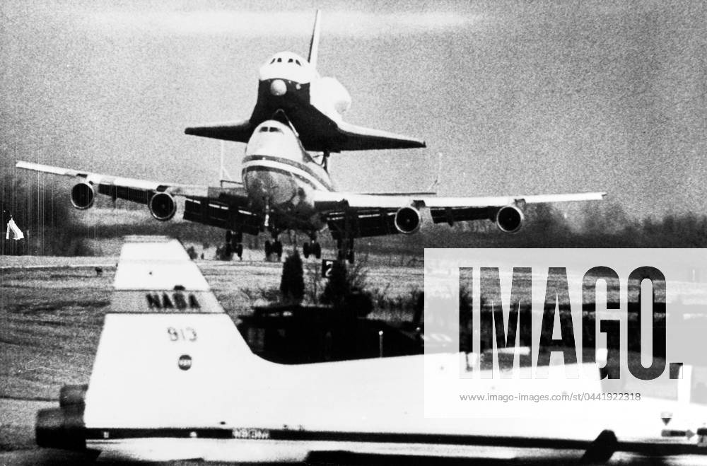 SHUTTLE ENTERPRISE, 1977. The Space Shuttle Enterprise, riding atop its 747 jumbo carrier, landing at Redstone Army Airfield during flight tests, 1977.
