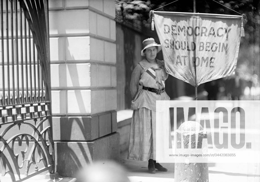 WHITE HOUSE: SUFFRAGETTE. A suffragette picketing in front of the White House, Washington, D.C., 1917.