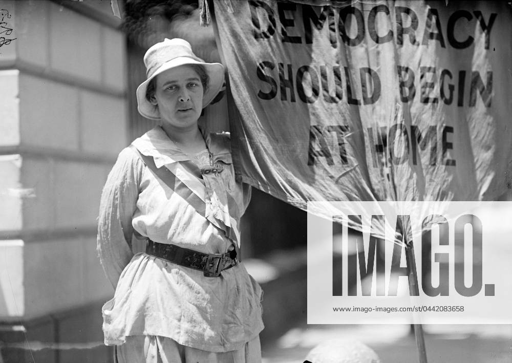WHITE HOUSE: SUFFRAGETTE. A suffragette picketing in front of the White House, Washington, D.C., 1917.