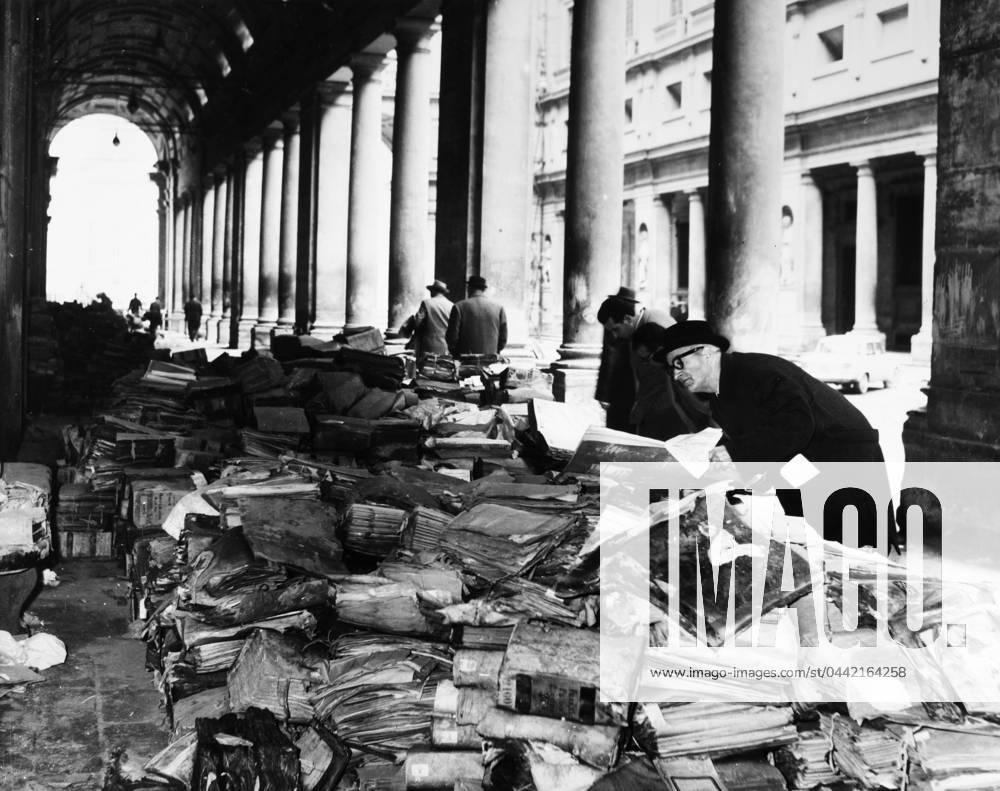 FLORENCE: FLOOD, 1966. Books and manuscripts from the Florence State Archives damaged during the flood of the Arno River, piled in front of the Uffizi Gallery. Photograph 21 November 1966.