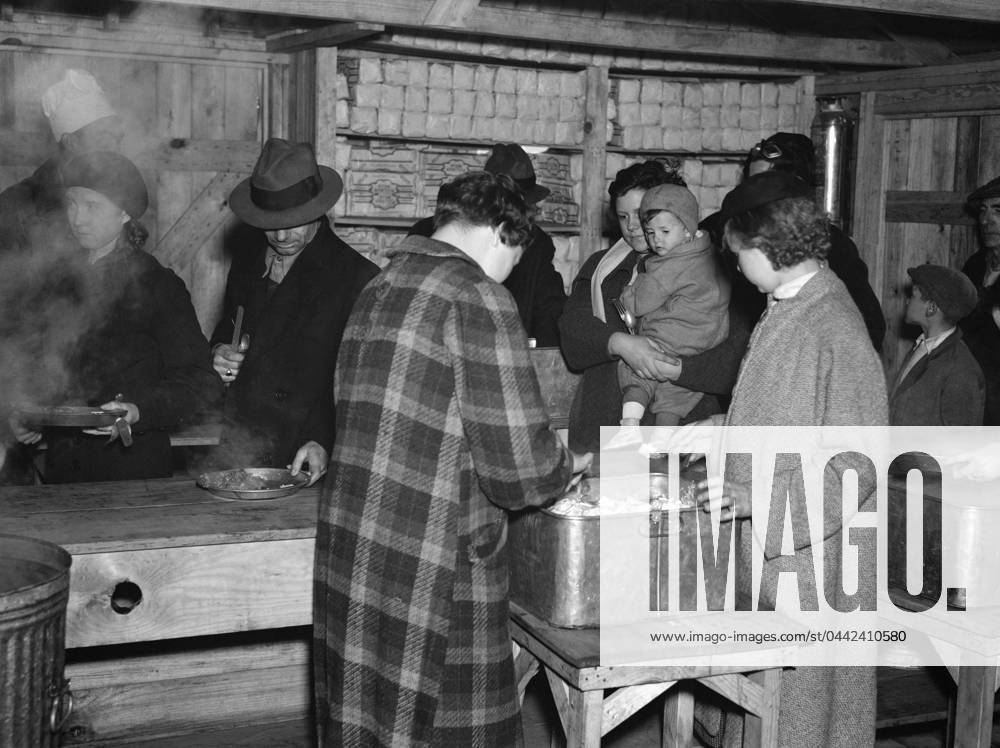 FLOOD REFUGEES, 1937. Flood refugees being fed at Tent City, near Shawneetown, Illinois. Photograph by Walker Evans, April 1937.