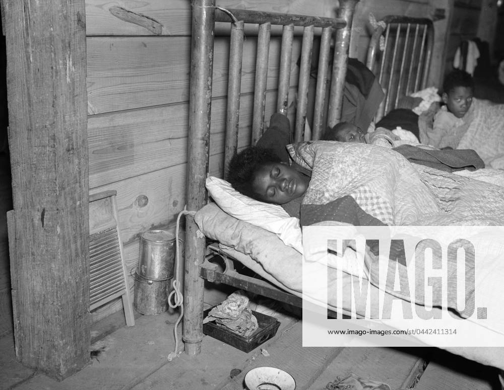 RED CROSS INFIRMARY, 1937. Sick flood refugees in the Red Cross temporary infirmary at a flood refugee camp in Forrest City, Arkansas. Photograph by Walker Evans, February 1937.