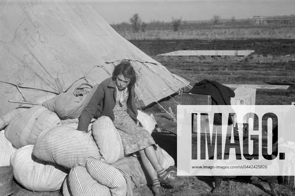ARKANSAS: FLOOD CAMP, 1937. A young girl in a camp for white flood refugees at Forrest City, Arkansas. Photograph by Walker Evans, February 1937.