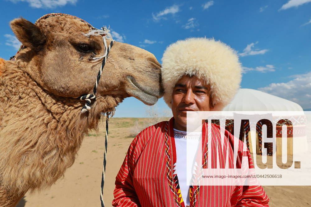 KW13 TURKMENISTAN, ANAU - MARCH 26, 2024: A man in traditional clothes and a camel are seen near a yurt. The town of Anau has been designated Cultural Capital of the Turkic World for 2024. Vladimir Smirnov TASS 68565938