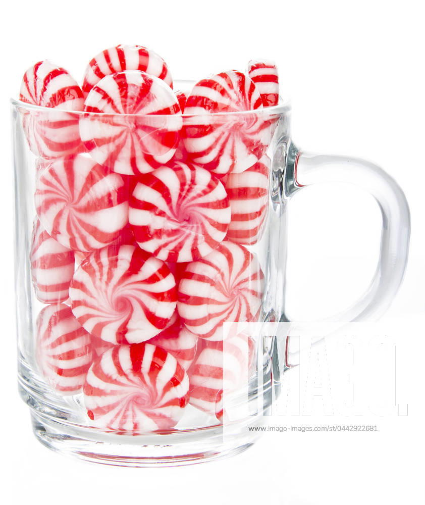 Cup of candy hard red and white candy mints in a transparent cup