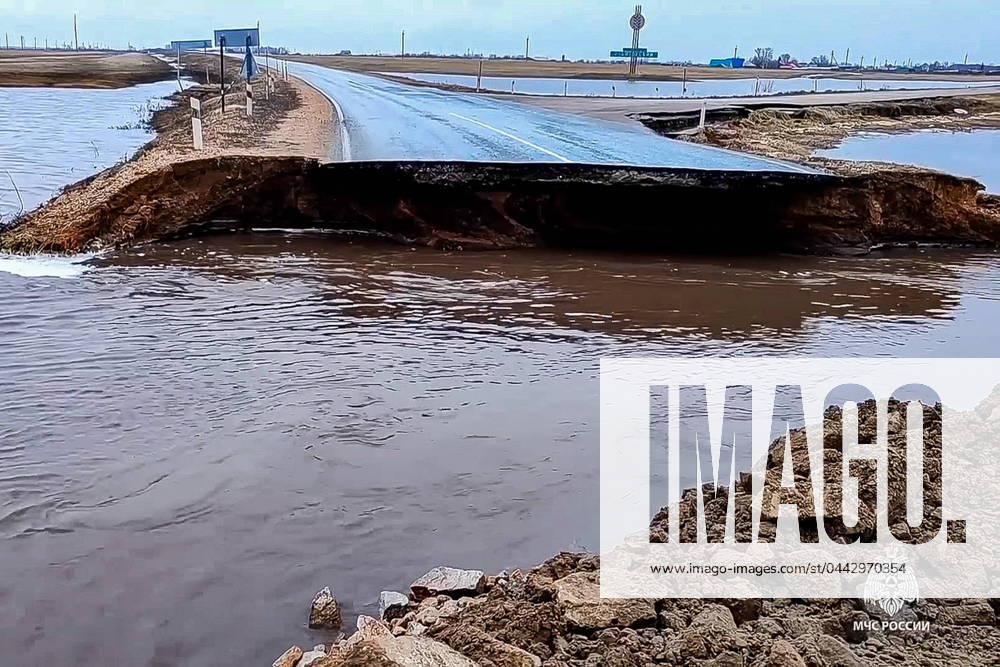 RUSSIA, ALTAI REGION - MARCH 31, 2024: A road is washed out during spring floods. Employees of the Russian Emergencies Ministry are providing the population with all necessary assistance on a round-the-clock basis. Water pumping and landfilling of low-lying areas are arranged, dams are being constructed, and meltwater channels are being laid. Evacuation of livestock and animals is underway. Video grab. Best possible quality. Russian Emergencies Ministry TASS 68655730