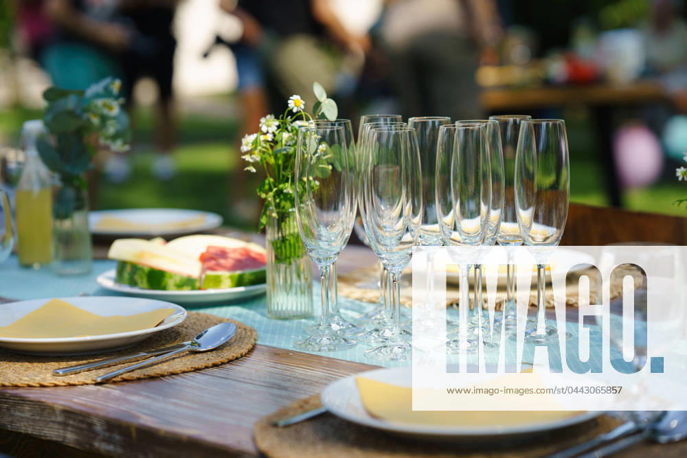 Close up shot of empty wine glasses, cutlery and utensils at summer garden party. Close up shot of empty wine glasses cutlery, utensils at summer garden party. model released