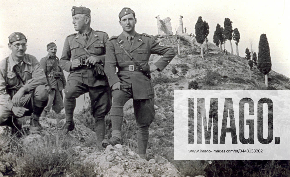 Portrait of a group of four soldiers in uniform photographed on a rocky promontory observing the surroundings. One of them has a spyglass. Behind them are a few cypresses and ruins at the top of a hill, 05 1938 (b w photo) 1250005 Portrait of a group of four soldiers in uniform photographed on a rocky promontory observing the surroundings. One of them has a spyglass. Behind them are a few cypresses and ruins at the top of a hill, 05 1938 (b w photo) by Unknown photographer, (20th century); (add.info.: Unidentified Author); Fratelli Alinari Museum Collections, Florence, Italy.