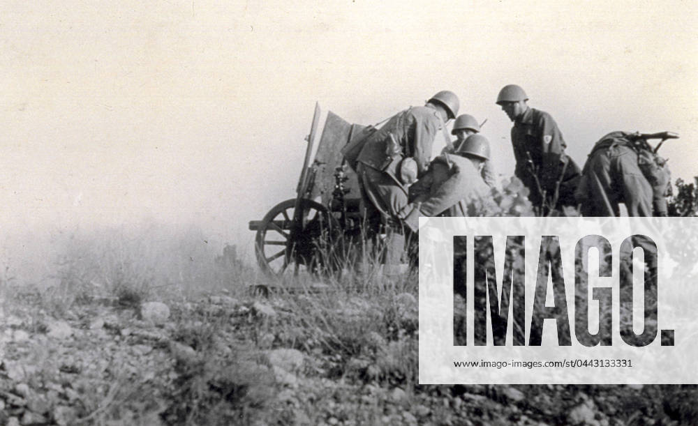 A few Italian soldiers commanded by captain Tognetti busy setting up and aiming a cannon against the enemy during the action known as Del Levante on the afternoon of July 14, 1938 (b w photo) 1250022 A few Italian soldiers commanded by captain Tognetti busy setting up and aiming a cannon against the enemy during the action known as Del Levante on the afternoon of July 14, 1938 (b w photo) by Unknown photographer, (20th century); (add.info.: Unidentified Author Spain); Fratelli Alinari Museum Collections, Florence, Italy.
