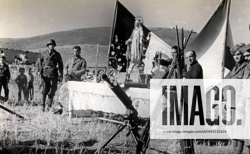 Snapshot taken during mass at the Italian military camp in Alba in Spain, in the course of the Spanish civil war, in August 1938. A few Italian soldiers, some Spanish children and a priest are around a table which is covered with white cloth and serves as altar. On top of it are the missal on a lectern, candelabras, a crucifix and a statuette of the Madonna. Behind them are the Italian and Spanish flags (b w photo) 1250081 Snapshot taken during mass at the Italian military camp in Alba in Spain, in the course of the Spanish civil war, in August 1938. A few Italian soldiers, some Spanish children and a priest are around a table which is covered with white cloth and serves as altar. On top of it are the missal on a lectern, candelabras, a cru