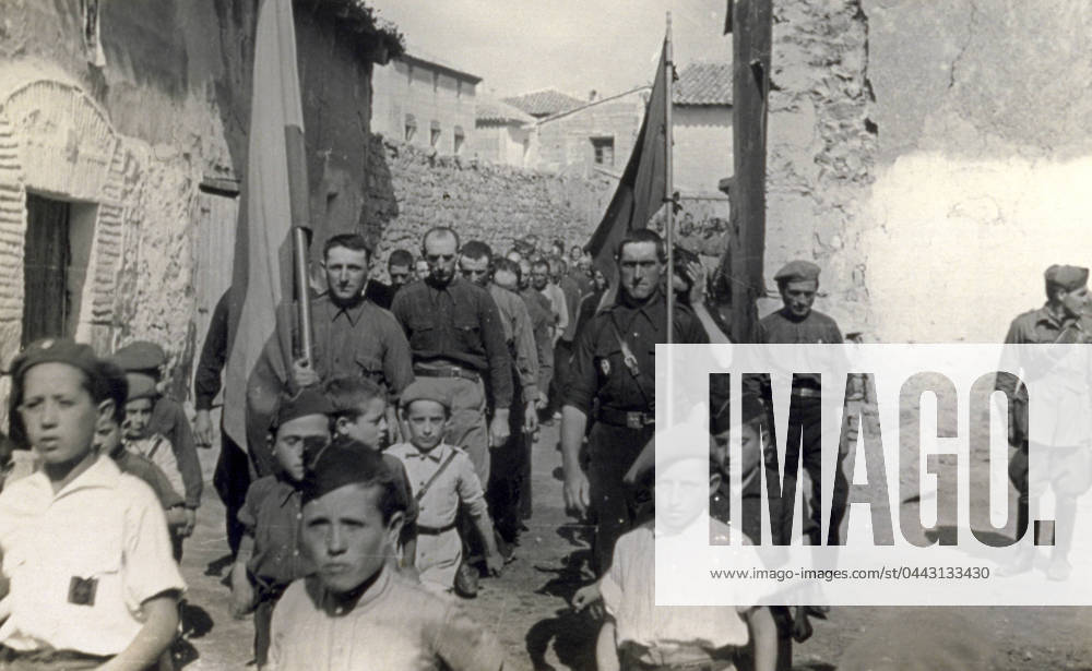 Snapshot of the procession on the day of the Caudillo along the streets of Alba in 1938, during the Spanish civil war. Children, men wearing the typical fascist black shirts and soldiers are walking along yhe street carrying the Spanish and Italian flags (b w photo) 1250089 Snapshot of the procession on the day of the Caudillo along the streets of Alba in 1938, during the Spanish civil war. Children, men wearing the typical fascist black shirts and soldiers are walking along yhe street carrying the Spanish and Italian flags (b w photo) by Unknown photographer, (20th century); (add.info.: Unidentified Author Spain); Fratelli Alinari Museum Collections, Florence, Italy.