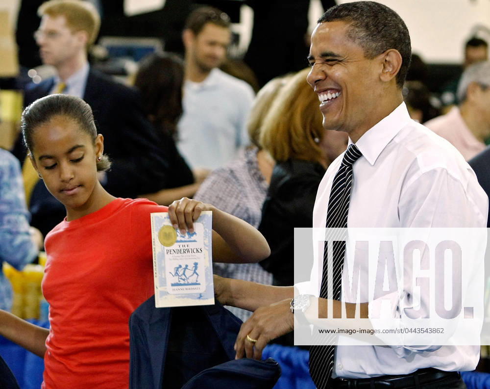 Obama6408.JPG.Washington, DC - June 25, 2009 -- United States President Barack Obama (R) and his daughter Malia (L) help volunteers and members of Congress stuff backpacks with books, food and photographs of the first dog Bo during a United We Serve event at Fort McNair June 25, 2009 in Washington, DC. Helping to fill 10,000 backpacks for children of military servicemen and women, the first family stuffed copies of The Lightning Thief, by Rick Riordan, and The Penderwicks, by Jeanne Birdsall into backpacks along with food items and a personal letter from the president and the first lady. .Photo by Chip Somodevilla POOL-CNP-PHOTOlink. Washington DC USA