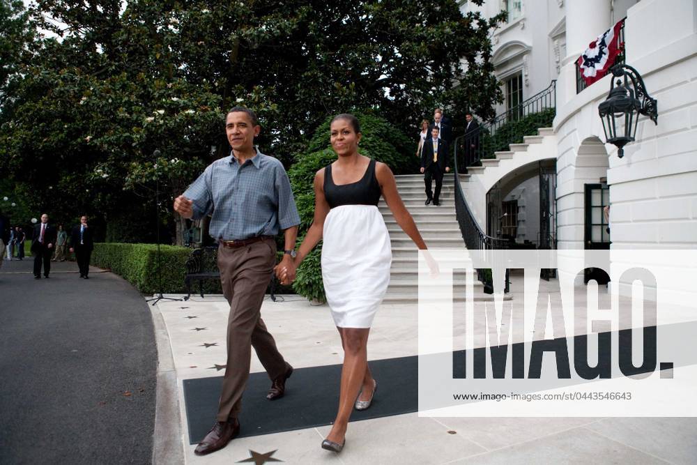 Obama1662.JPG.Washington, DC - July 4, 2009 -- United States President Barack Obama and First Lady Michelle Obama make their way from White House to shake hands with guests at a gathering of military families at the White House on July 4, 2009 in Washington, DC. President Obama is leaving tomorrow on a trip to Russia, Italy, and Ghana. .Digital Photo by Brendan Hoffman POOL-CNP-PHOTOlink. Washington DC USA