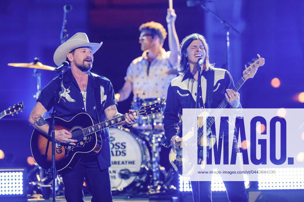 American country rock band NEEDTOBREATHE with lead singer BEAR RINEHART performs at a taping of CMT Country Crossroads in front of the University of Texas Tower on April 5, 2024. At right is bassist SETH BOLT Austin United States - ZUMAd150 20240405_znp_d150_019