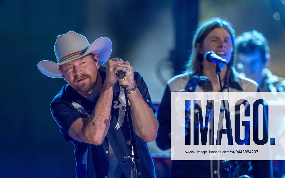 American country rock band NEEDTOBREATHE with lead singer BEAR RINEHART performs at a taping of CMT Country Crossroads in front of the University of Texas Tower on April 5, 2024. At right is bassist SETH BOLT Austin United States - ZUMAd150 20240405_znp_d150_020