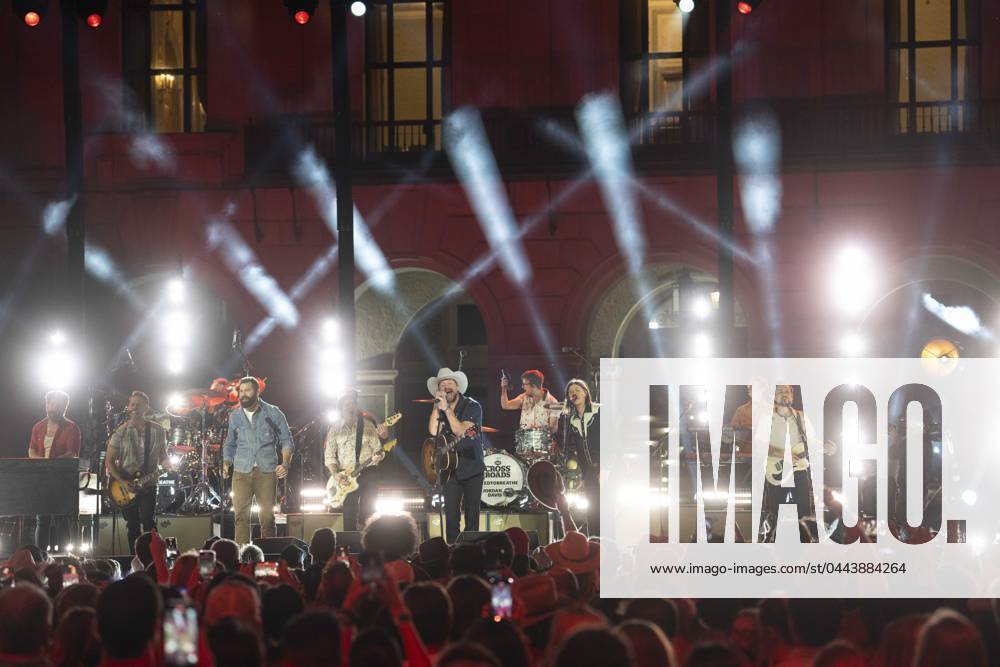 American country rock band NEEDTOBREATHE with lead singer BEAR RINEHART, r, teams up with country pop singer JORDAN DAVIS, l, to perform at a taping of CMT Country Crossroads in front of the University of Texas Tower on April 5, 2024. At far right is bassist SETH BOLT. Austin United States - ZUMAd150 20240405_znp_d150_036