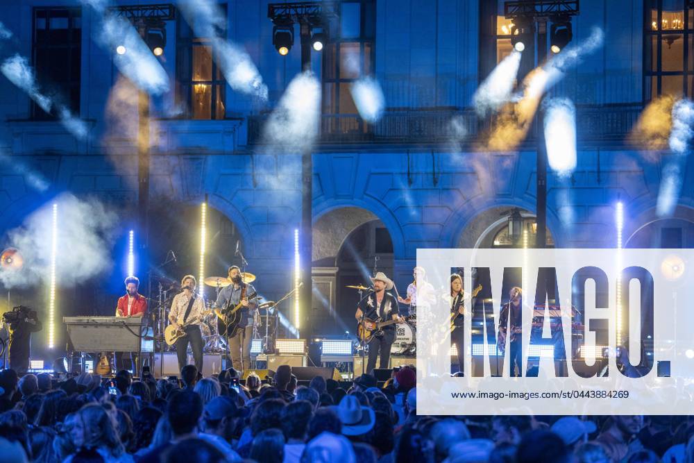 American country rock band NEEDTOBREATHE with lead singer BEAR RINEHART, r, teams up with country pop singer JORDAN DAVIS, l, to perform at a taping of CMT Country Crossroads in front of the University of Texas Tower on April 5, 2024. At far right is bassist SETH BOLT. Austin United States - ZUMAd150 20240405_znp_d150_038