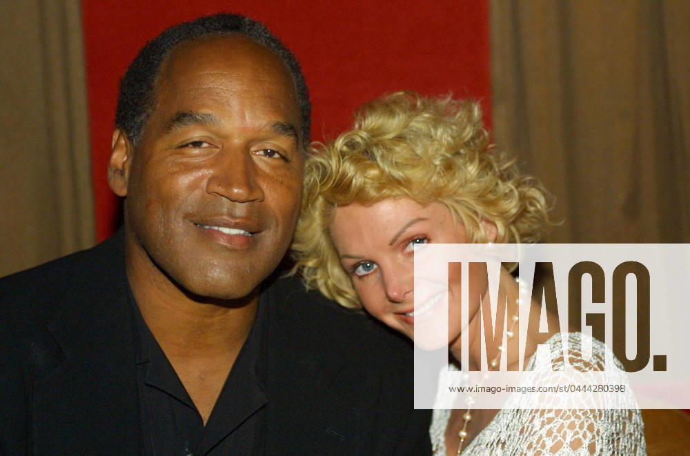 **FILE PHOTO** O.J. Simpson Has Passed Away. EXCLUSIVE Miami Beach, FL 2-7-02 OJ Simpson and friend Tammy Wu enjoy a night out at KISS Restaurant. Photo by Adam Scull PHOTOlink MediaPunch