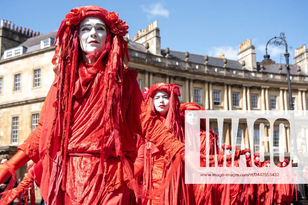 Red Rebels march on the street of Bath during the funeral for nature ceremony. Extinction Rebellion held a funeral for nature march across in Bath, UK. Chris Packham and Megan McCubbin (both TV presenters) joined the march along with 400 Red Rebels. Bath United Kingdom - ZUMAs197 20240420_aaa_s197_186