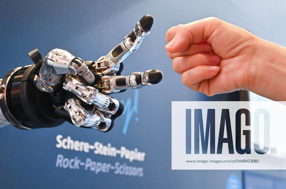 (240423) -- HANNOVER (GERMANY), April 23, 2024 -- A visitor plays rock paper scissors with an intelligent robot at Hannover Messe in Hannover, Germany, on April 23, 2024. Hannover Messe 2024, Germany s leading industrial trade fair, kicked off on Monday with a clear emphasis on carbon-neutral production and hydrogen fuel cells. ) GERMANY-HANNOVER-HANNOVER MESSE RenxPengfei