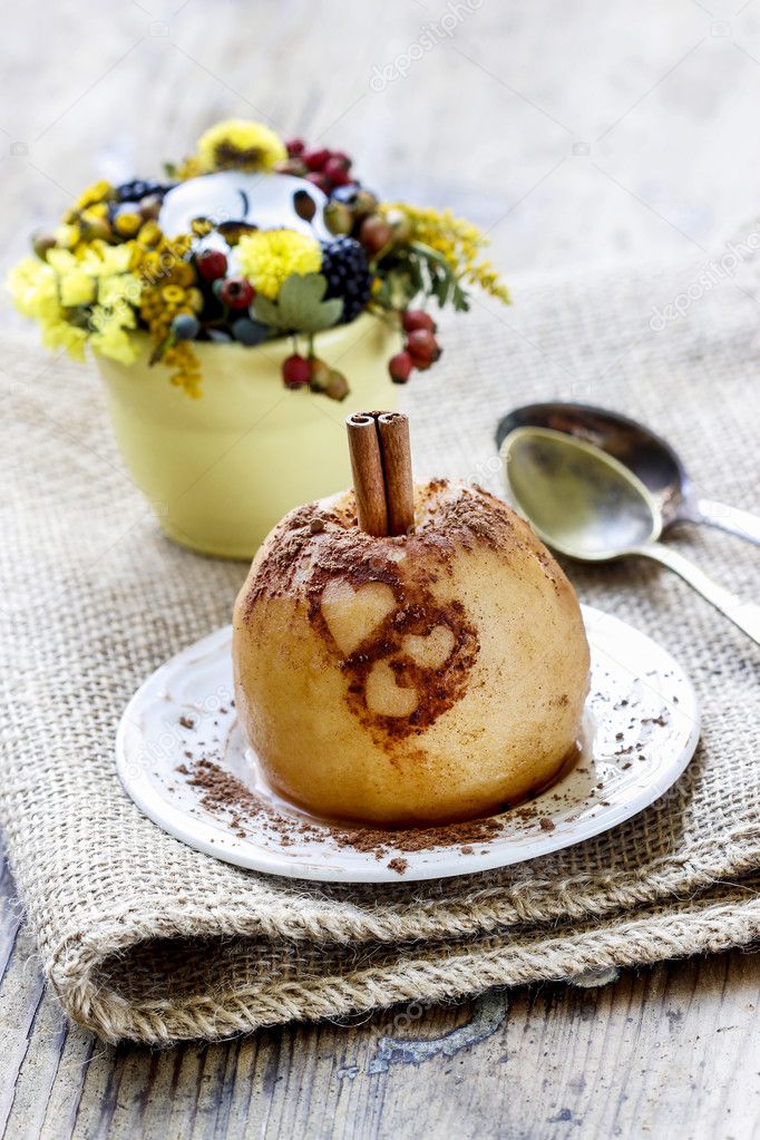 Baked apple decorated with cinnamon heart shape ornament