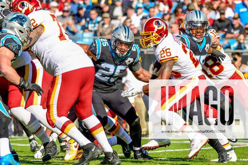 CHARLOTTE, NC - DECEMBER 01: Washington Redskins running back Adrian Peterson (26) is met at the line of scrimmage by Carolina Panthers strong safety Eric Reid (25) on a run during the game between the Carolina Panthers and the Washington Redskins at Bank of America Stadium on December 01, 2019 in Charlotte, NC. (Photo by William Howard Icon Sportswire) NFL, American Football Herren, USA DEC 01 Redskins at Panthers Icon19120103