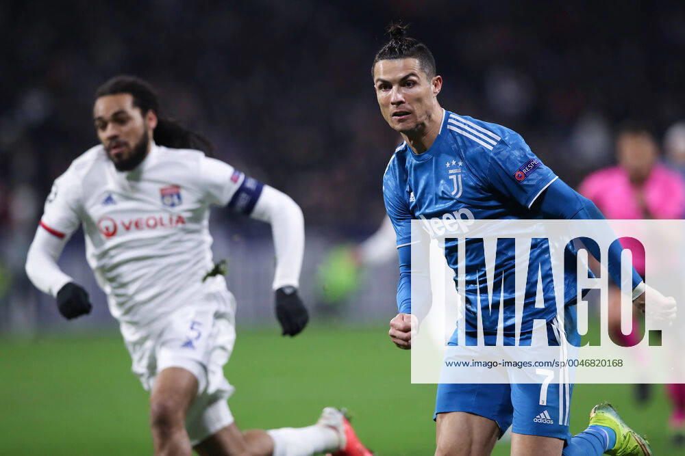 Juventus s Portuguese striker Cristiano Ronaldo advances forwards followed by Lyon s Belgian defender Jason Denayer during the UEFA Champions League match at the Groupama Stadium, Lyon. Picture date: 26th February 2020. Picture credit should read: Jonathan Moscrop Sportimage . SPI-0491-0023