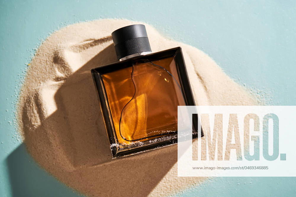 A bottle of perfume on a background of sand. A bottle of perfume on a background of sand. High quality photo.