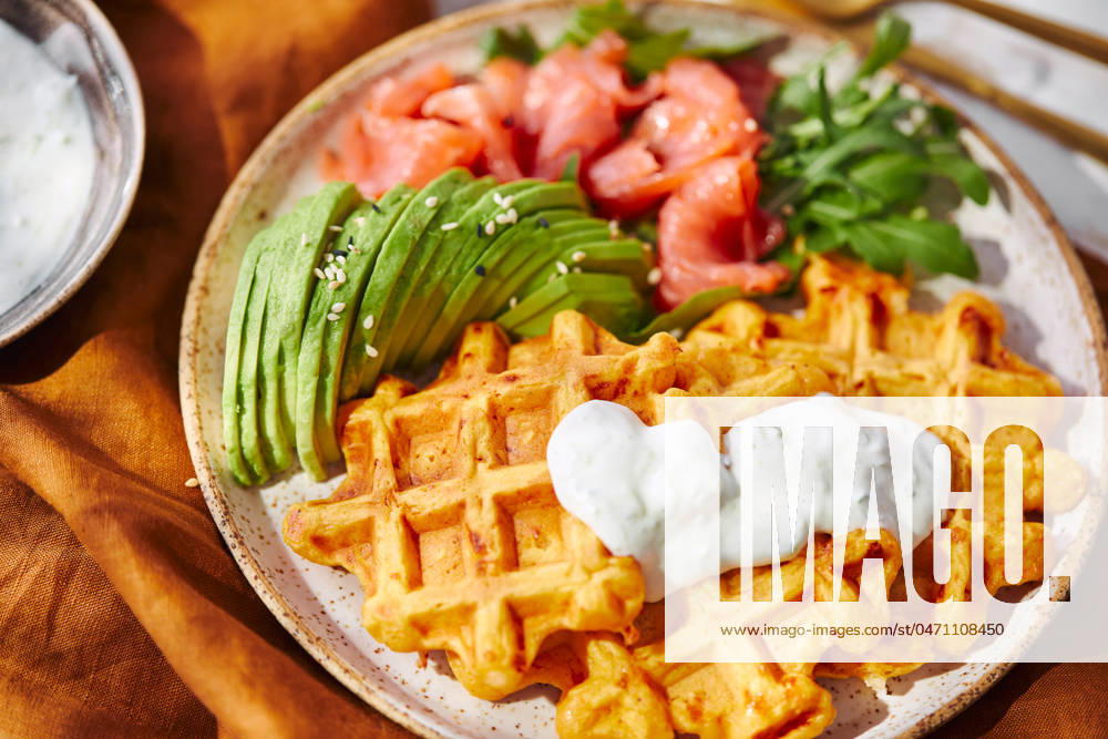 Hearty sweet potato or pumpkin waffles with avocado, salmon, arugula and sauce Hearty sweet potato or pumpkin waffles with avocado, salmon, arugula and sauce