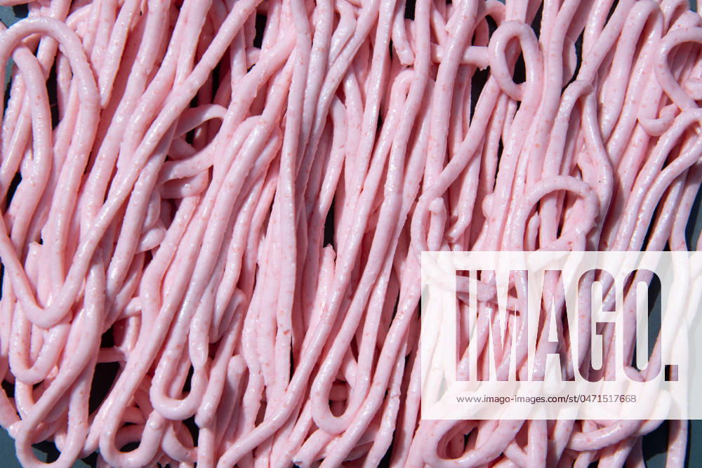 Pink tarama pasta on a gray plate squeezed out of a cooking bag,creative texture pink tarama pasta on a gray plate squeezed out of a cooking bag, creative texture. High quality photo