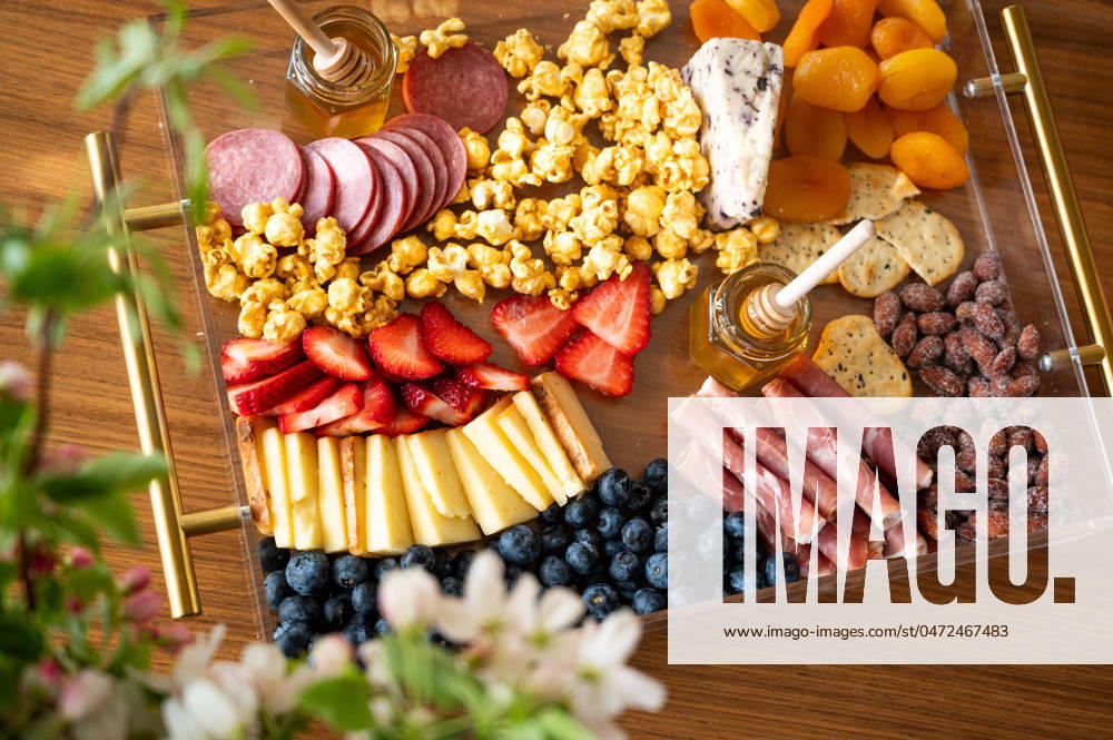 Charcuterie board adorned with cheeses, fruits, and cured meats. Syracuse, Utah, United States CR_WMWJ240502-1420250-01