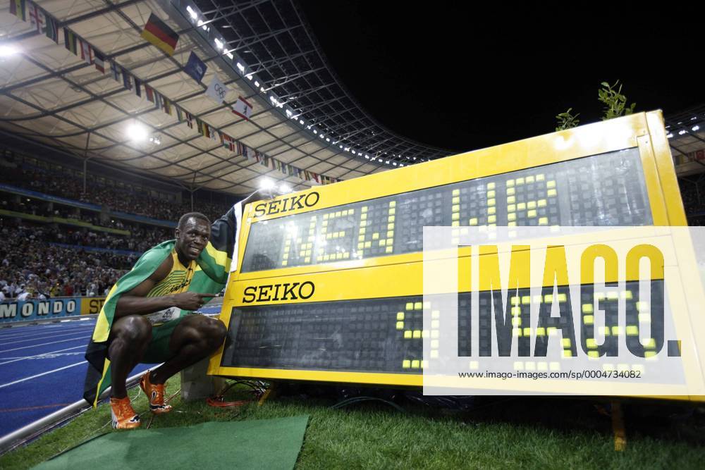 Jamaica s Usain Bolt celebrates beside the result board after winning the men s 100m final. Bolt set a new world record with a time of 9.58 seconds and claimed the title of the event.