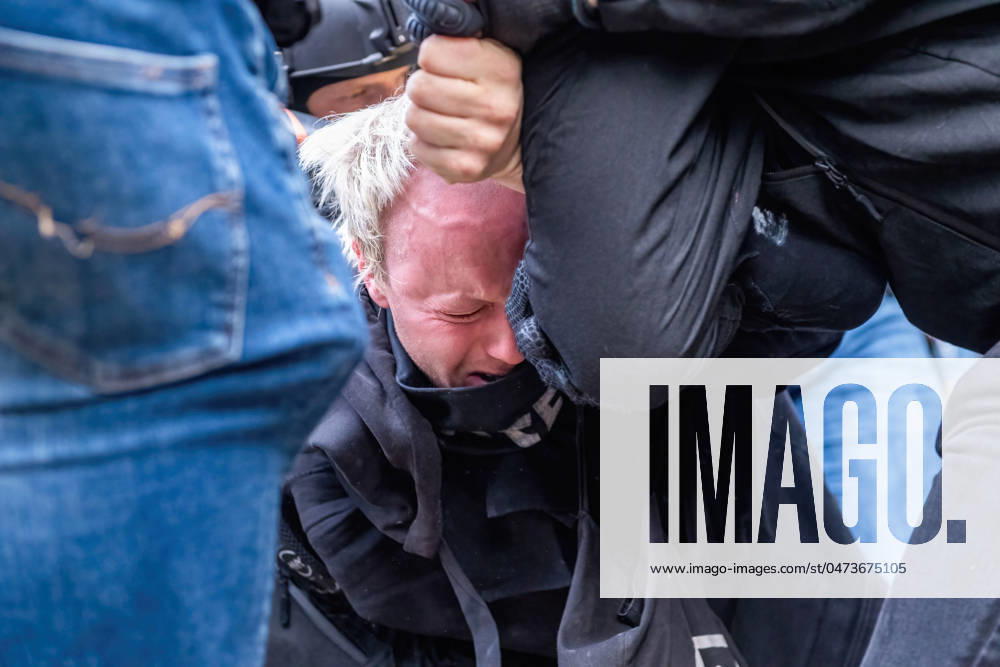 Police end student occupation in Amsterdam, Netherlands - 08 May 2024 Plain clothes police beat a student as they arrest and drag him away after police broke through barricades to end a Pro-Palestine student occupation at the University of Amsterdam. Police dismantle a pro-Palestine student protest and occupation at the University of Amsterdam, employing batons, shields, and earth-moving equipment. The confrontation ensued as demonstrators rallied for Palestinian solidarity amid tensions, law enforcement intervened to disperse the crowd, resulting in clashes and arrests. Amsterdam Netherlands