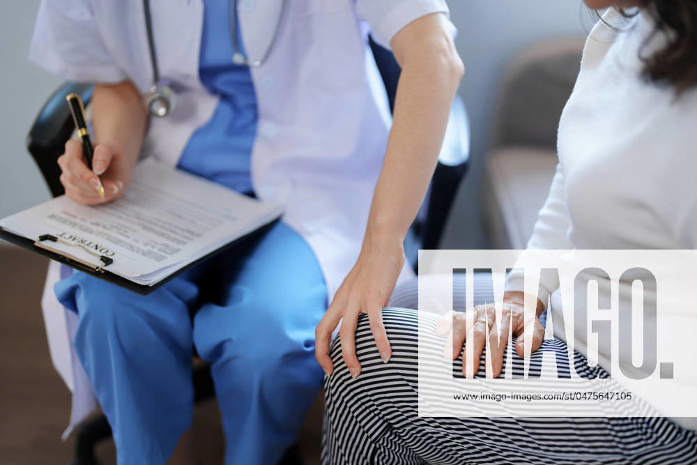 Portrait of a female doctor talking to a patient with knee pain. Portrait of a female doctor talking to a patient with knee pain
