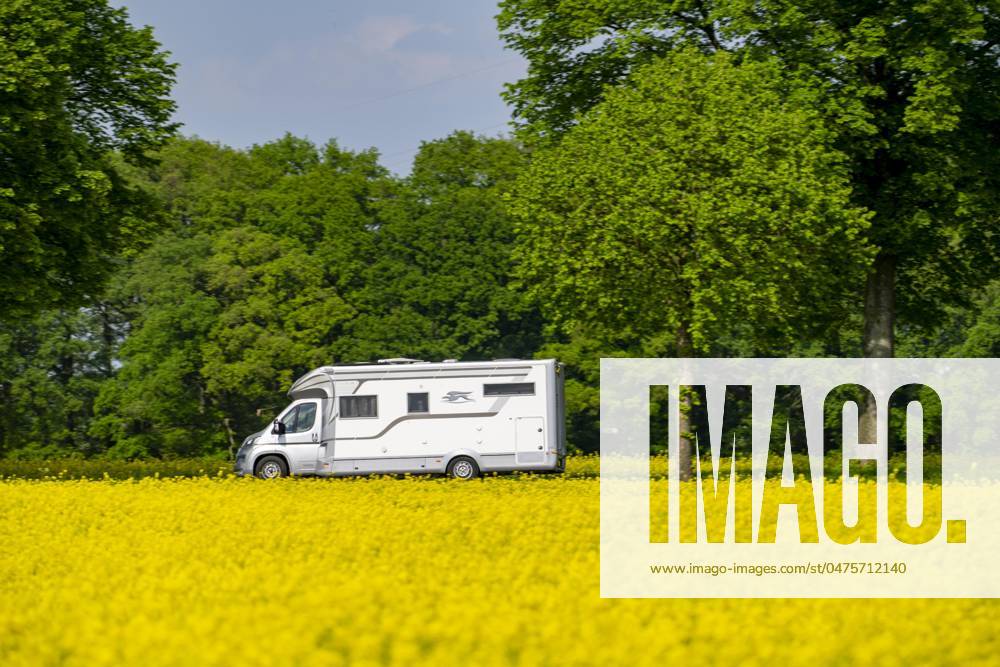 Landscape on the Lower Rhine, motorhome on the federal highway B57, between Xanten and Kalkar, road traffic, NRW, Germany, country road rape field