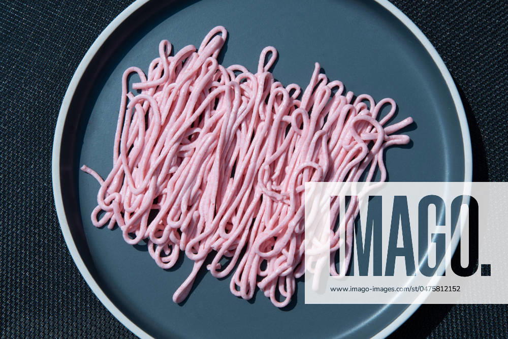 Pink tarama pasta on a gray plate squeezed out of a cooking bag,creative texture pink tarama pasta on a gray plate squeezed out of a cooking bag, creative texture. High quality photo
